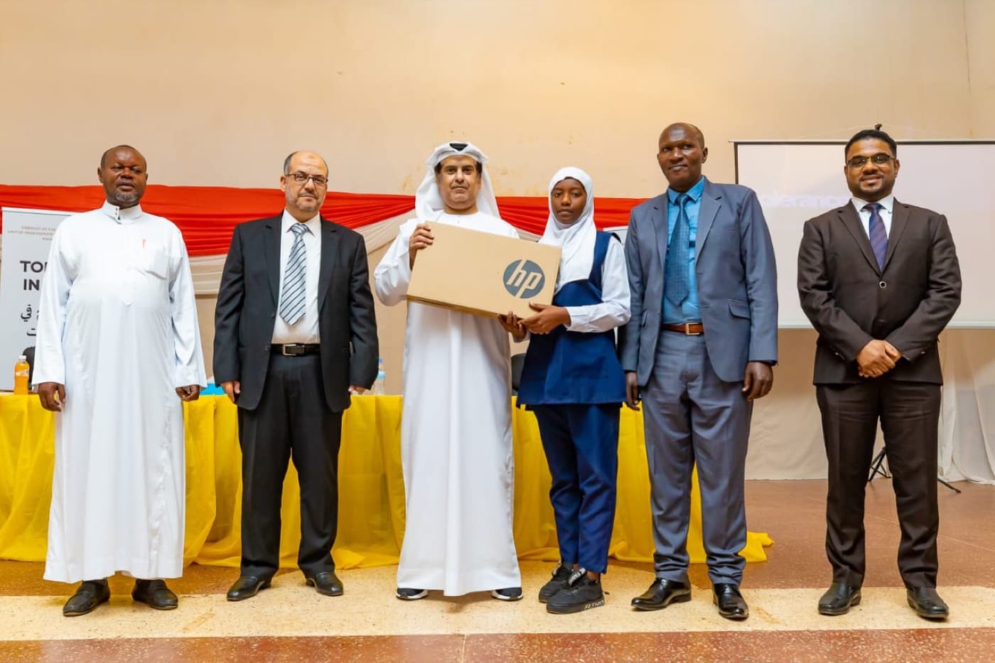 The UAE ambassador to Rwanda presenting the Best Student of the Year award