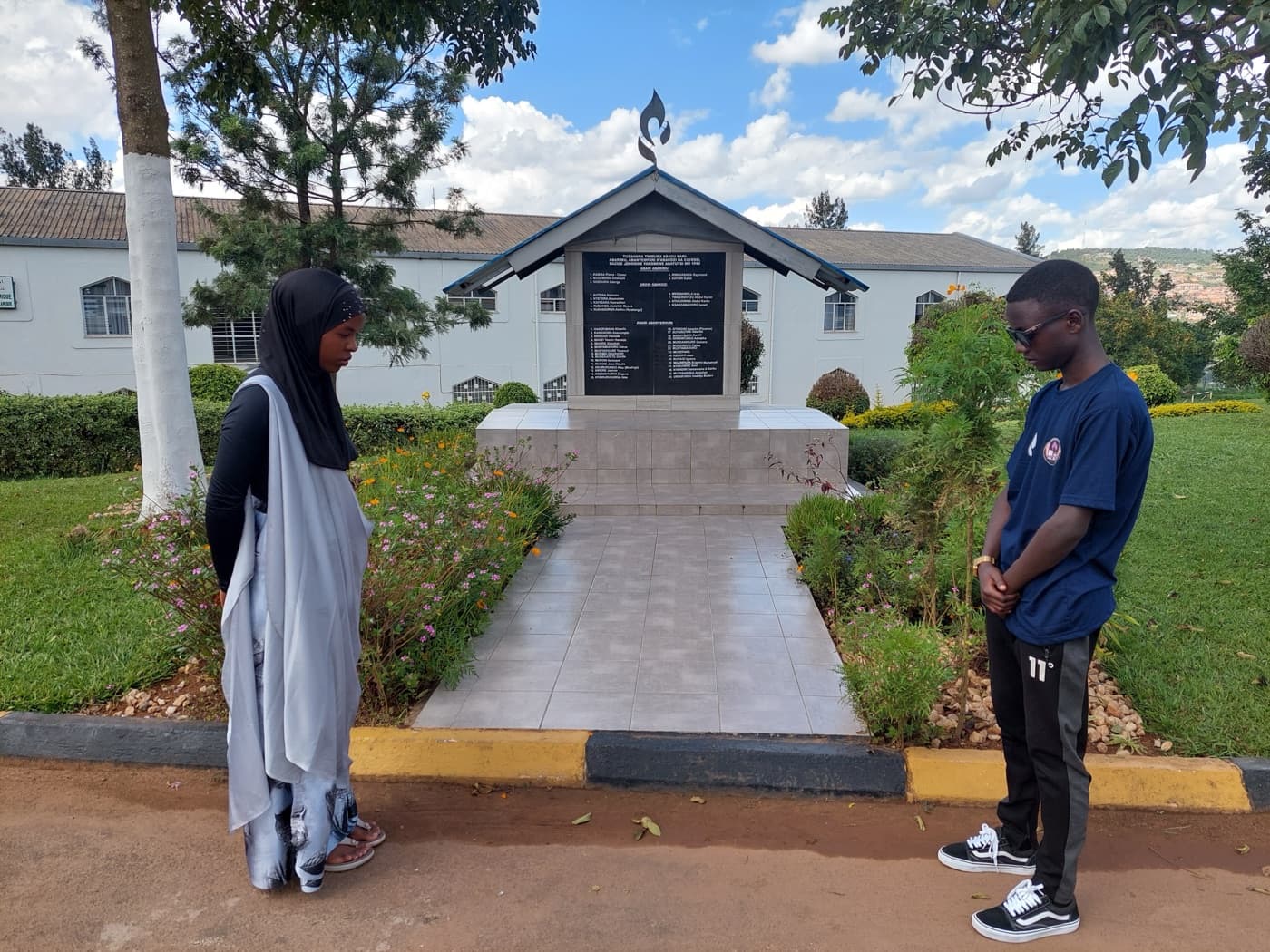 Students at the Kwibuka memorial on the ESSI Nyamirambo school grounds
